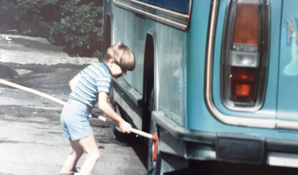 Our Story Alex washing the buses